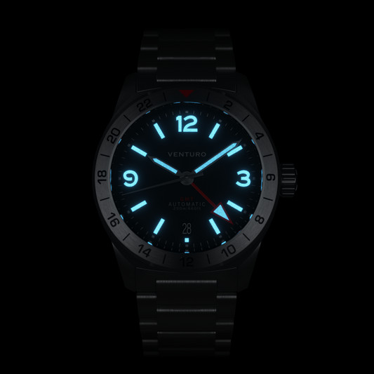 Black wristwatch with glowing blue face on a white background