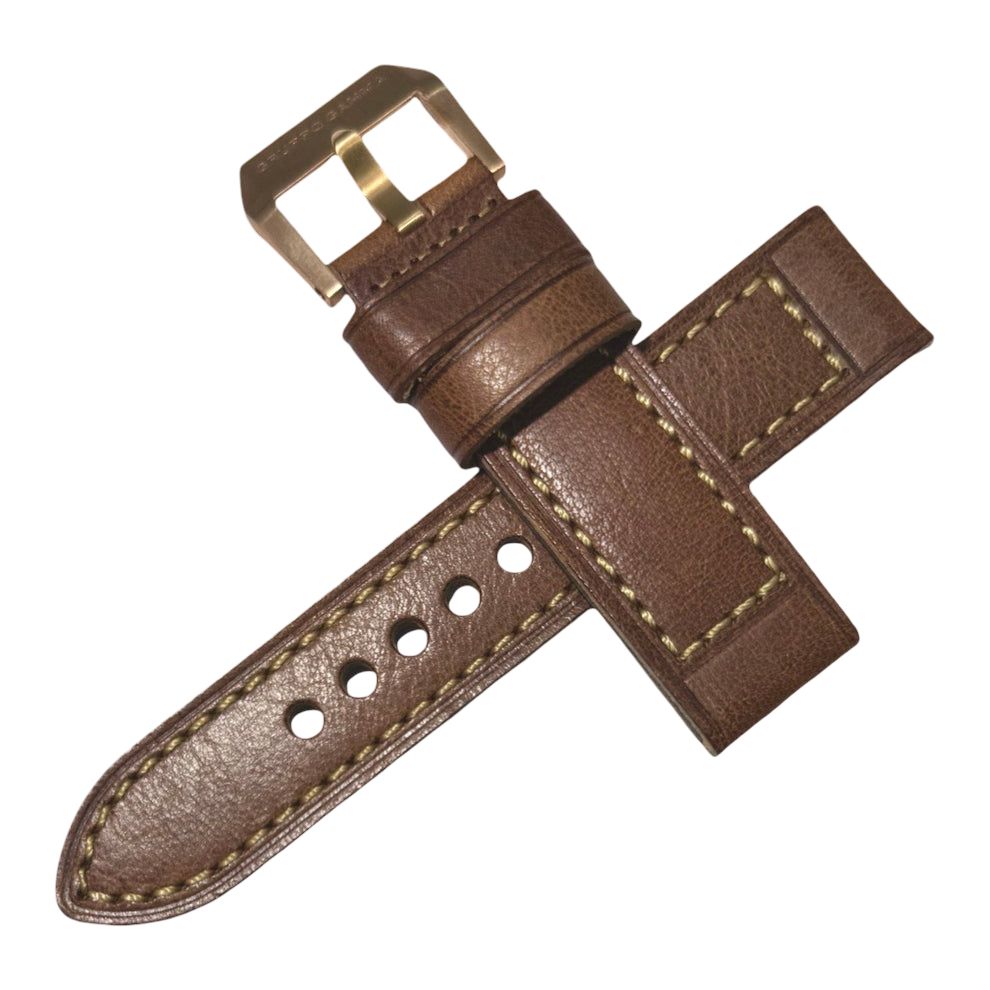 Brown leather watch strap with gold buckle on a white background