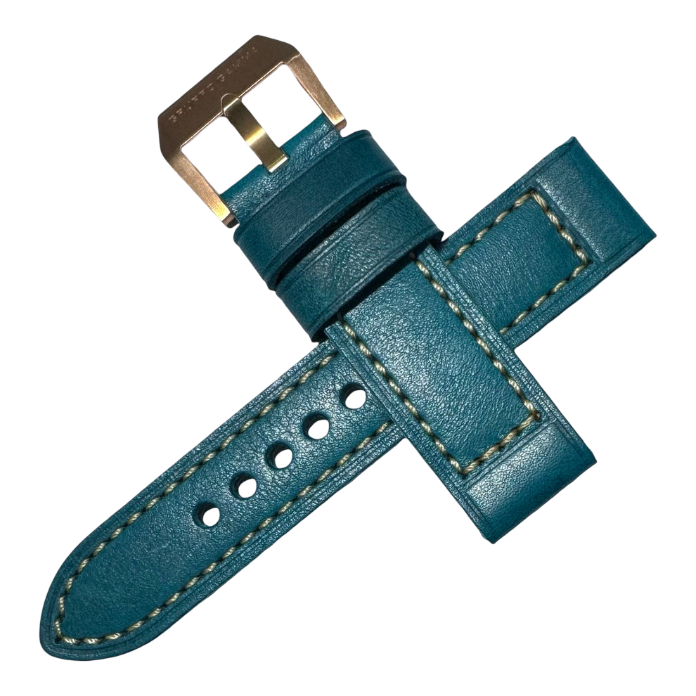 Teal leather watch strap with gold buckle on a white background