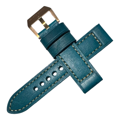 Teal leather watch strap with gold buckle on a white background