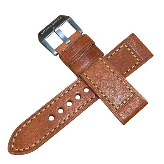 Brown leather watch strap with silver buckle on a white background