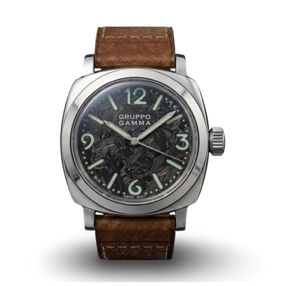 A Gruppo Gamma wristwatch with a polished stainless steel case, luminous forger carbon dial with C3 markers, and a brown leather strap.