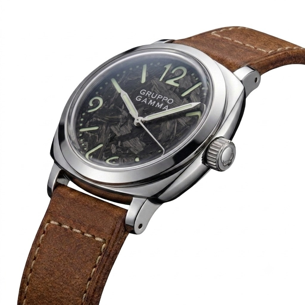 A Gruppo Gamma wristwatch featuring a brown leather strap, a silver-toned stainless steel case, and a black dial with luminous Arabic numerals and hands.