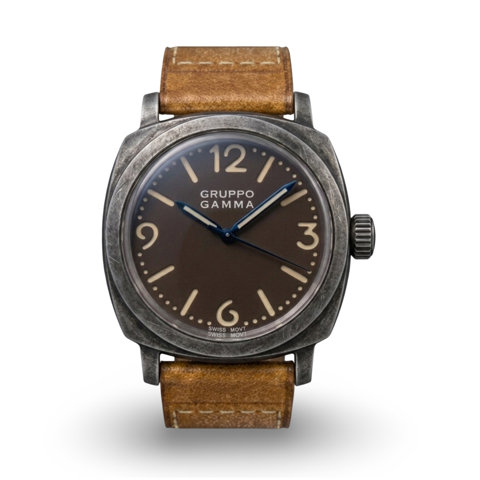 A Gruppo Gamma wristwatch with an aged steel dark gray case, a tropical dark brown dial with beige Arabic numerals and steel blue hands, and a brown leather strap.