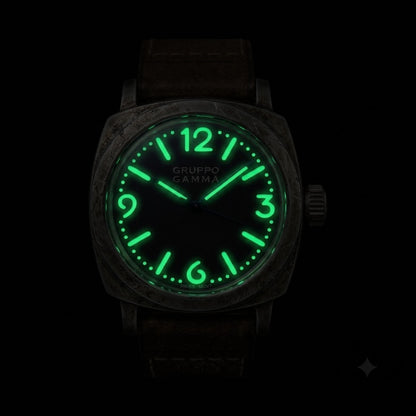 A Gruppo Gamma wristwatch with an aged steel case and a glowing green luminescent dial and numerals, shown against a solid black background.