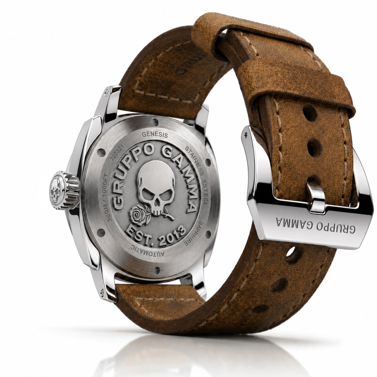 A close-up studio shot of the back of a wristwatch with a brown leather strap and a stainless steel case. The case is engraved with a skull and rose logo and the brand name 'GRUPPO GAMMA'.