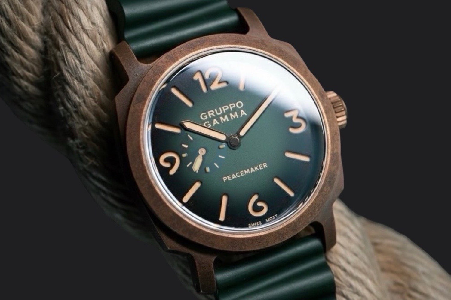 Watch with green strap and dark green dial on a textured surface