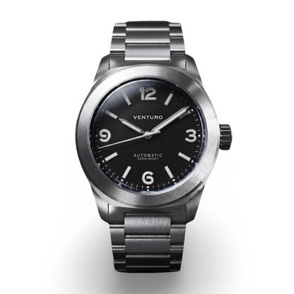 Silver watch with black dial on a white background