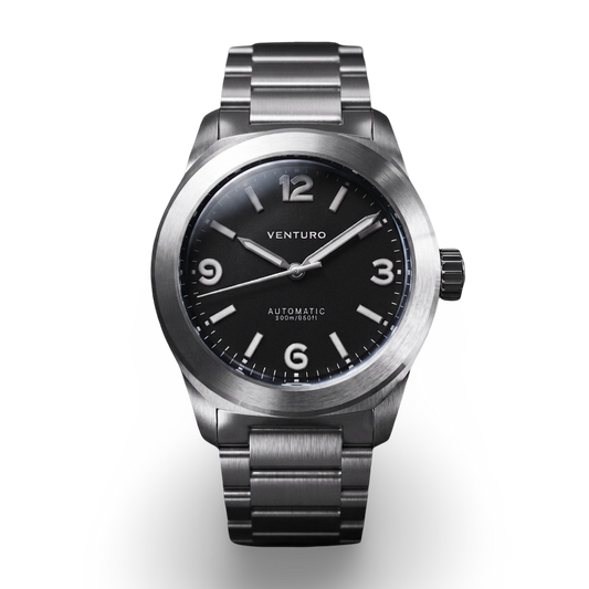 Silver watch with black dial on a white background